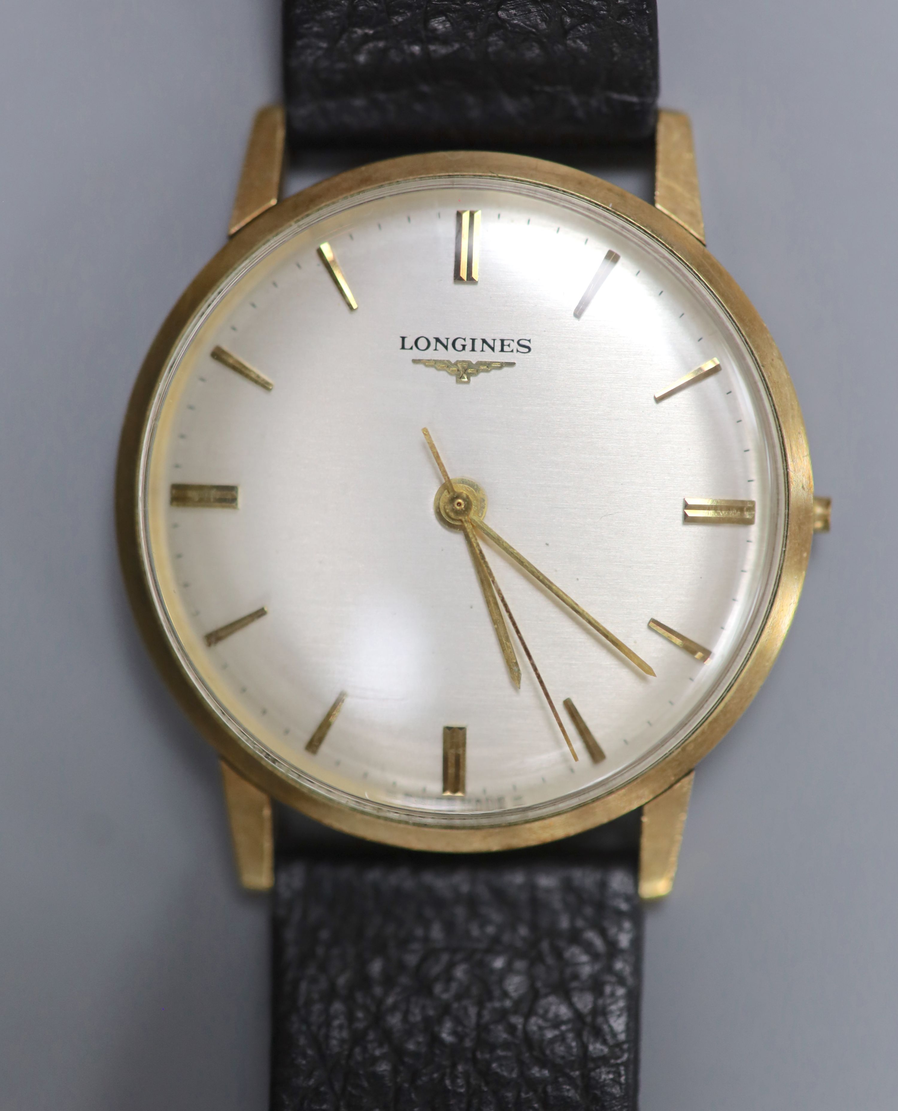 A gentleman's 1960's 9ct gold Longines manual wind wrist watch (lacking winding crown), with case back inscription.